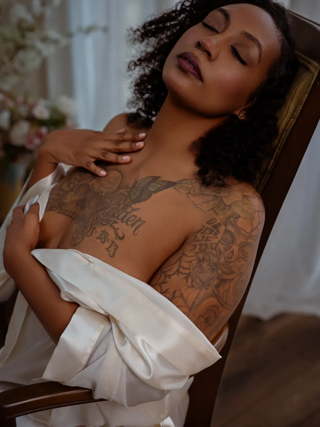 Relaxed boudoir portrait in a white satin robe